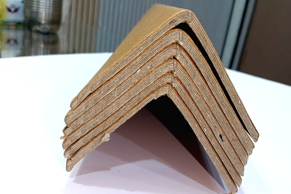 Cartons stacked on pallets in a warehouse, the kind of load paper angle board protects at the corners